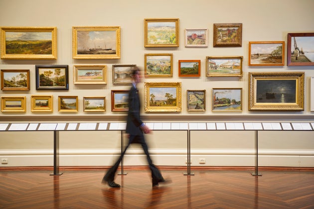 Blurred view of person walking in art museum