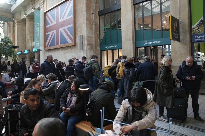 Travelers wait as Eurostar trains to London and all trains heading to northern France have been brought to a halt following the discovery of an unexploded bomb dating back to World War II near the tracks on Friday, March 7, 2025, at the Gare du Nord station in Paris.