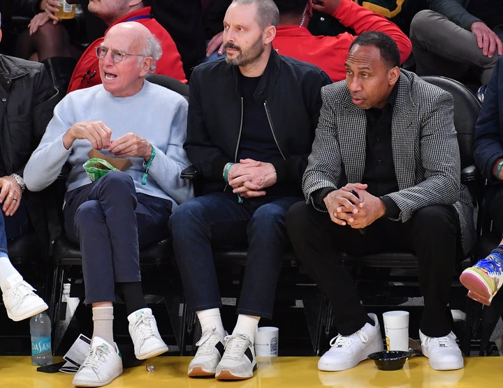 Smith (right) was seated next to none other than Larry David (left) during Thursday's game.