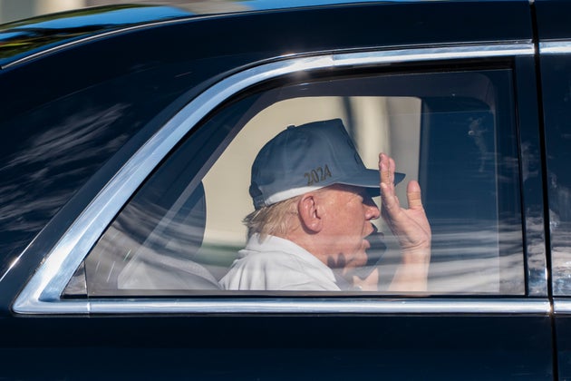 President Donald Trump waves and talks on the phone as he arrives at the Trump International Golf Club on March 2, 2025, in West Palm Beach, Florida. 