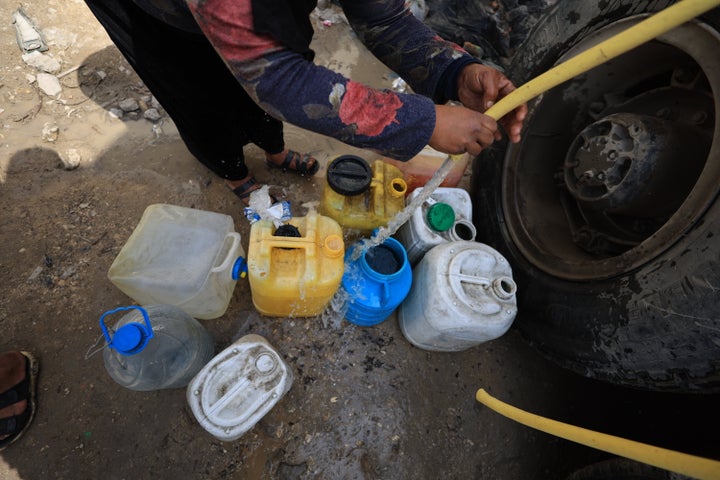 GAZA CITY, GAZA - MARCH 05: Palestinians, who go through a water crisis due to Israel's blocking of fuel from the Kerem Abu Salim border crossing, which has disrupted the supply of electricity to water treatment plants, fill their containers from water tankers in the Shujaiyye neighborhood of eastern Gaza City, Gaza on March 05, 2025. (Photo by Dawoud Abo Alkas/Anadolu via Getty Images)