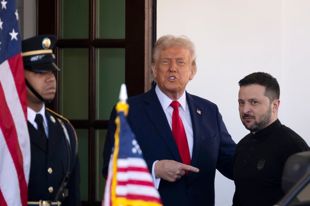 Ukraine President Volodymyr Zelenskyy, right, is greeted by President Donald Trump, center, as he arrives at the White House in Washington, Friday, Feb. 28, 2025. (AP Photo/Ben Curtis)