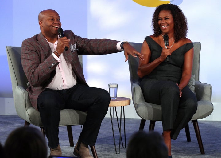 Former first lady Michelle Obama and her brother, Craig Robinson, converse in 2019 during a session of the Obama Foundation Summit at the Kaplan Institute at the Illinois Institute of Technology in Chicago.