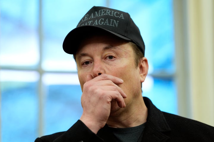 Elon Musk listens during an event in the Oval Office with President Donald Trump at the White House, Tuesday, Feb. 11, 2025, in Washington. (AP Photo/Alex Brandon)