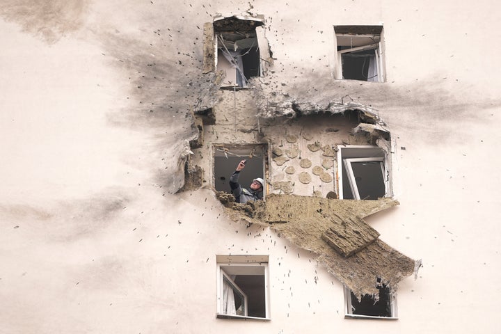 A investigator looks at the damage of an apartment building where a downed Ukrainian drone fell in Sapronovo village outside Moscow, Russia, on March 11, 2025.