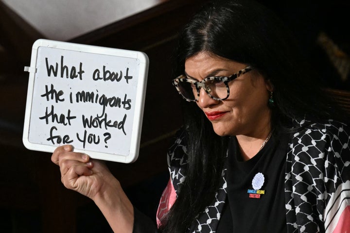 Rep. Rashida Tlaib (D-Mich.) holds up a white board reading, "What about the immigrants that worked for you?" as President Donald Trump delivers an address to a joint session of Congress in the U.S. Capitol in Washington, D.C., on March 4. Tlaib joined 13 other lawmakers in signing a letter demanding federal immigration enforcement release Palestinian activist Mahmoud Khalil from detention, after he was arrested for peacefully protesting the Israeli occupation last year on Columbia University's campus.