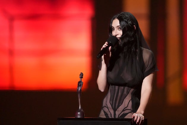 Charli XCX accepting an award during the 2025 Brit Awards