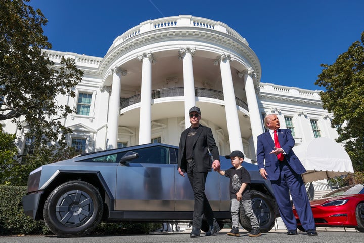 President Donald Trump and Tesla CEO Elon Musk, along with his son X Æ A-Xii, speak to reporters near Tesla vehicles on South Lawn of the White House Tuesday, March 11, 2025, in Washington. (Pool via AP)