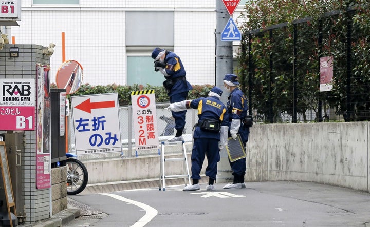 Japanese police investigators work Tuesday near the scene of a fatal stabbing in the Shinjuku district of Tokyo.