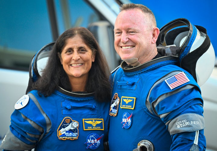 NASA astronauts Butch Wilmore (R) and Suni Williams, wearing Boeing spacesuits, depart the Neil A. Armstrong Operations and Checkout Building at Kennedy Space Center for Launch Complex 41 at Cape Canaveral Space Force Station in Florida to board the Boeing CST-100 Starliner spacecraft for the Crew Flight Test launch on June 5, 2024.