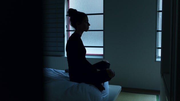 Woman with insomnia sitting up in bed