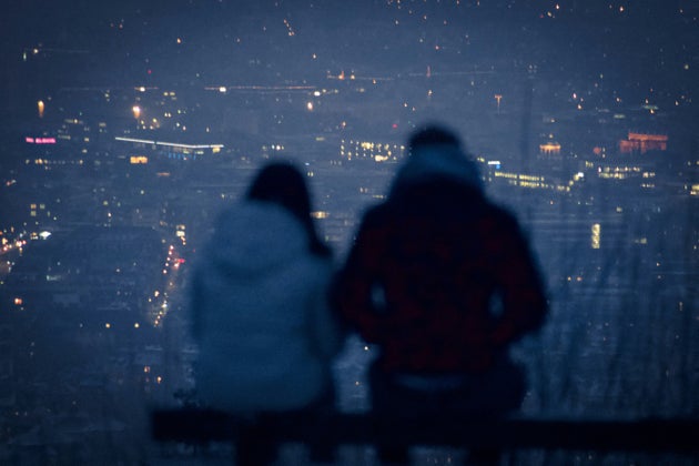 Blurry silhouette of couple in front of a city