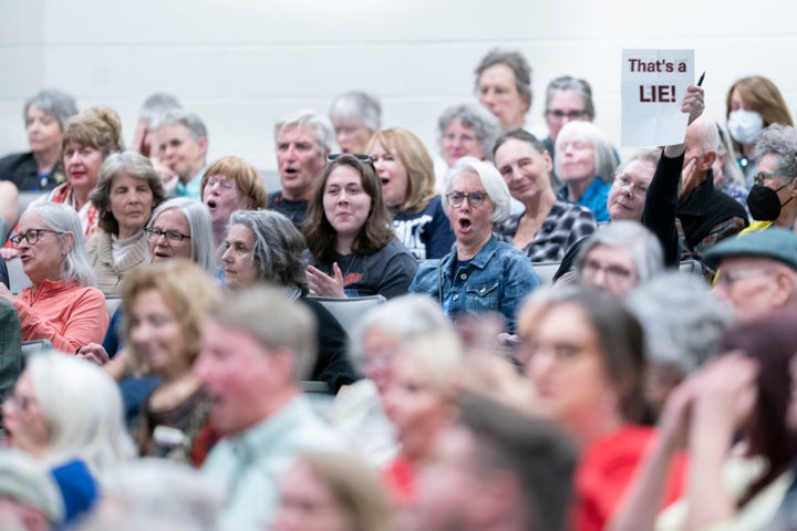 People react during a congressional town hall meeting with Rep. Chuck Edwards (R-N.C.) in Asheville, North Carolina.