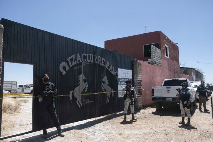 Police stand guard outside the entrance to Izaguirre Ranch on Thursday.