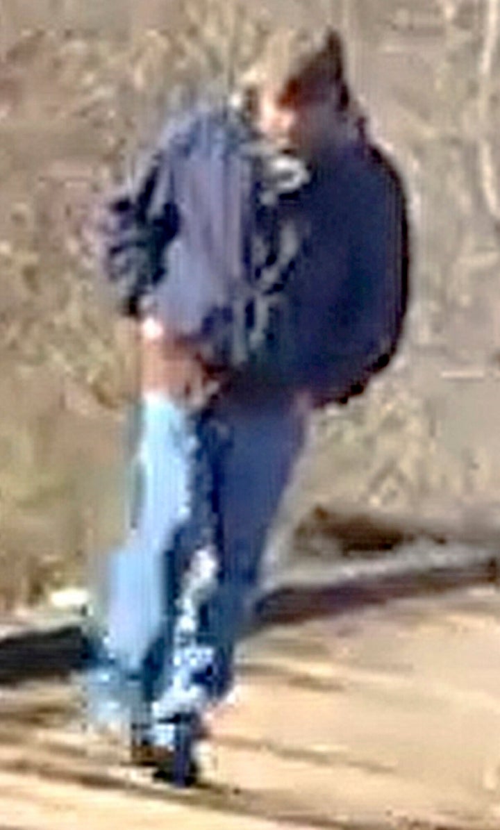 This photo released by the Indiana State Police shows a man walking along the trail system in Delphi, Indiana. The man was captured in a video taken by one of two girls who were later found murdered nearby.