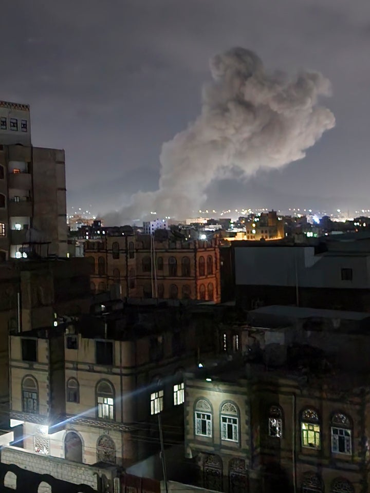 Smoke rises from a location reportedly struck by U.S. airstrikes in Sanaa, Yemen, Saturday, March 15, 2025. (AP Photo/Osamah Abdulrahman)