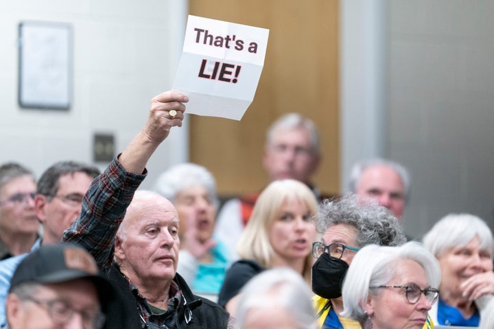 ASHEVILLE, NORTH CAROLINA - MARCH 13: A man holds up a sign reading "That's a LIE!" during a congressional town hall meeting with Rep. Chuck Edwards (R-NC) on March 13, 2025 in Asheville, North Carolina. The event comes as Republicans have faced protestors at town halls critical of the Trump administration slashing federal jobs. (Photo by Sean Rayford/Getty Images)