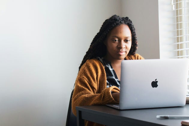 Woman looking apprehensively at computer