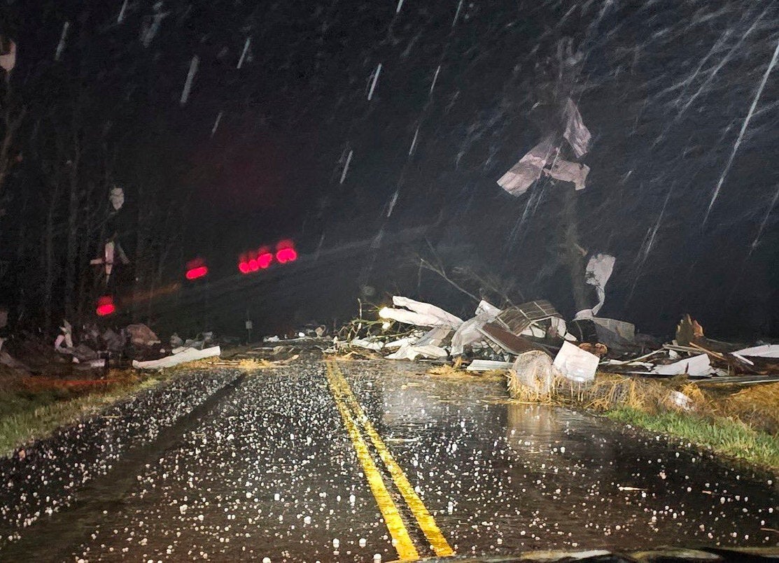 Debris covers the road during Friday's severe storm north of Seymour, Mo.