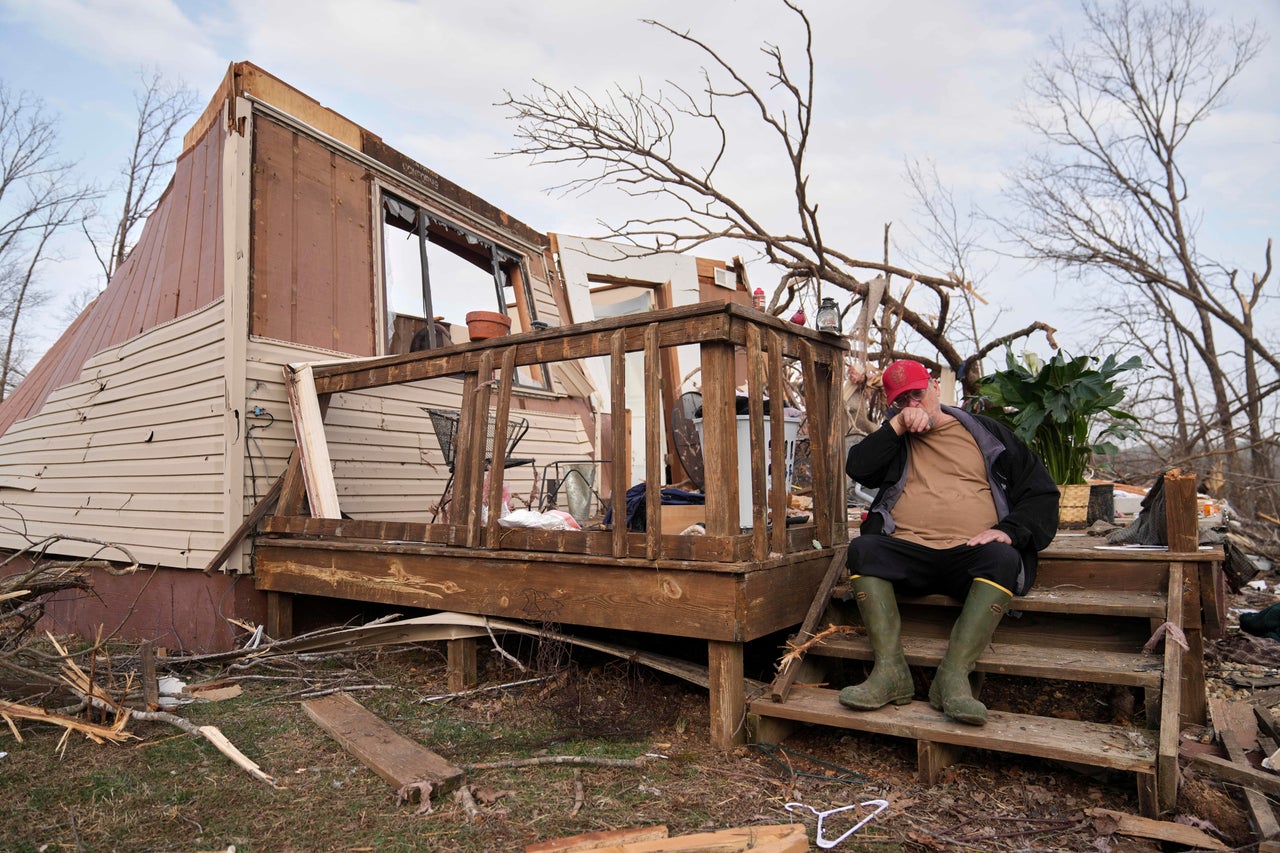 Tim Scott sits on the stairs of his home he was inside when it was destroyed during a severe storm in Wayne County, Mo.