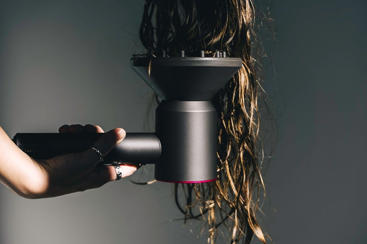 A diffuser attachment can coax curls and waves into more manageable patterns.