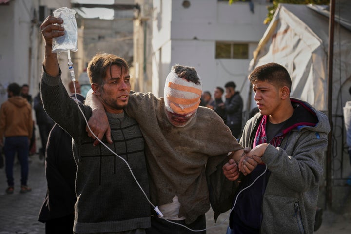 An injured man is taken to the Al-Ahli hospital following overnight Israeli army airstrikes across the Gaza Strip, in Gaza City, Tuesday, March 18, 2025. (AP Photo/Jehad Alshrafi).