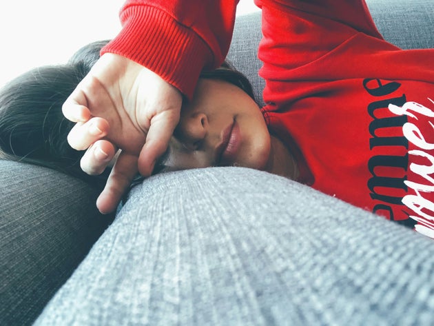 Exhausted woman sleeping on sofa