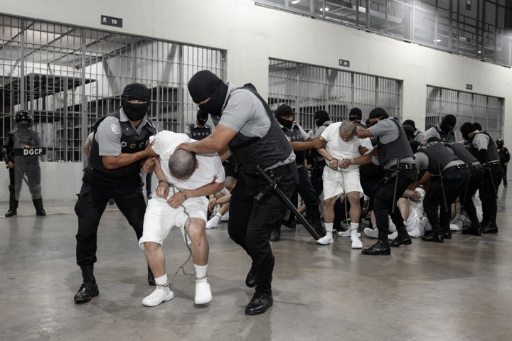 Prison guards in Tecoluca, El Salvador, restrain men the U.S. claims are members of the Tren De Aragua and Mara Salvatrucha gangs.