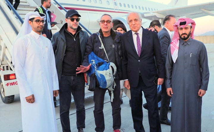 In this handout photo released by Qatar Ministry of Foreign Affairs, George Glezmann, center, poses with Adam Boehler, second left, and Zalmay Khalilzad, second right, and Qatari diplomats in Kabul, Afghanistan, Thursday, March 20, 2025, before departing to Doha, Qatar. (Qatar Ministry of Foreign Affairs via AP)