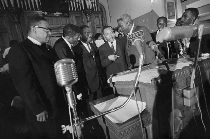 In the 1960s, Jackie Robinson protested social injustice alongside Martin Luther King Jr. Here, he stands to the right of the civil rights leader at a press conference in Birmingham, Alabama, in May 1963.