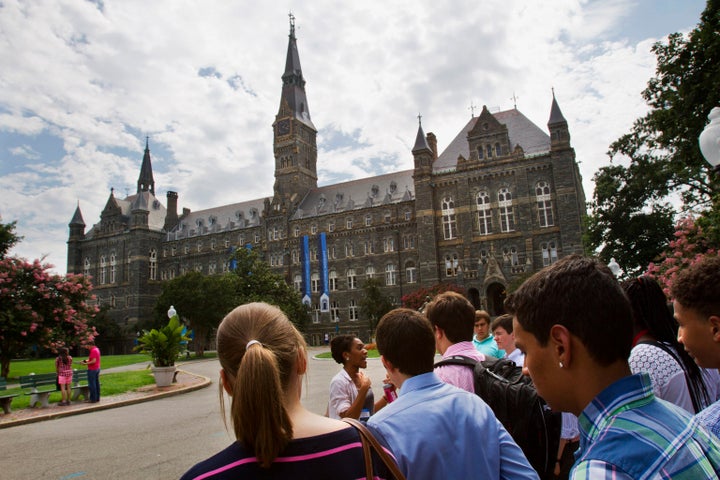 In this July 10, 2013, file photo, prospective students tour Georgetown University's campus in Washington.