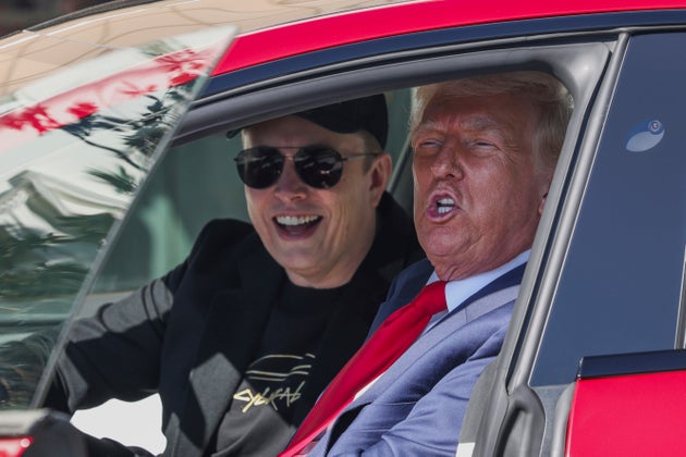 President Donald Trump and Tesla CEO Elon Musk speak to reporters as they sit in a red Model S Tesla vehicle on the South Lawn of the White House Tuesday, March 11, 2025, in Washington. 