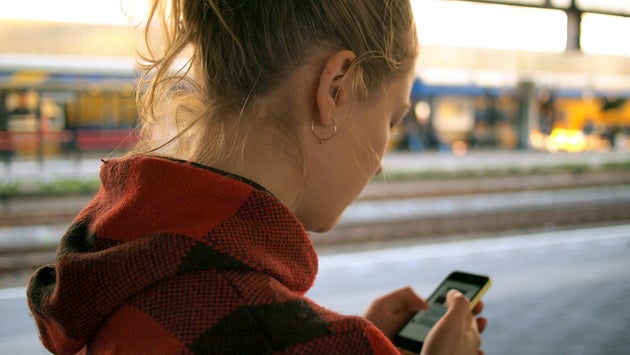 Young woman looking at phone screen