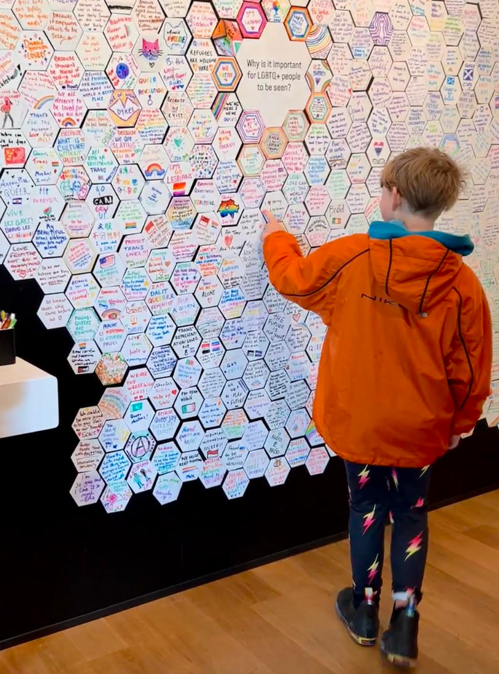 E. at the Queer Britain museum in London adding his thoughts to an exhibit about the importance of LGBTQ+ visibility.