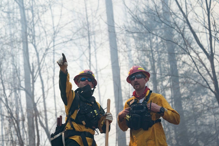 Firefighters work the Black Cove Fire on March 23, 2025 in Saluda, North Carolina. According to authorities, evacuation orders were issued Sunday for parts of Polk County, where three large wildfires have burned more than 3,000 acres combined, with two of the blazes remaining out of control.