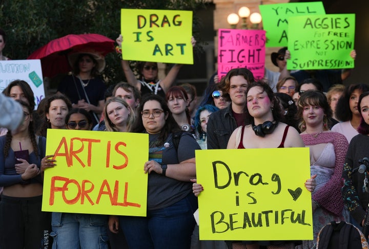 Attendees hold signs during a protest sponsored by Texas A&M University Queer Empowerment Council's Day of Drag on campus on March 6. The protest was against the school system's recent ban on drag shows at university event spaces.