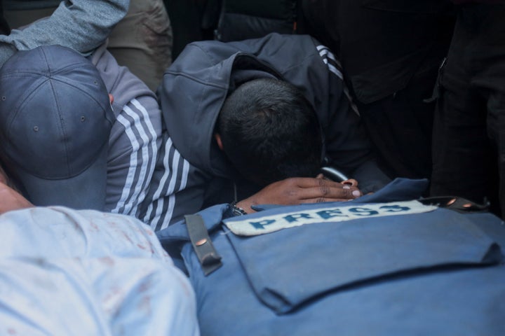 Family and friens mourn over the bodies of Palestine Today journalist Mohammad Mansour (L) and Hossam Shabat (R), a 23-year-old Al Jazeera journalist, who were killed by Israeli army on March 24, 2025 in Gaza Strip, Palestinian territories.