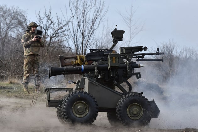  Ukrainian serviceman examines a drone at a military training ground in the Zaporizhzhia region, Ukraine, Wednesday, March 13, 2025