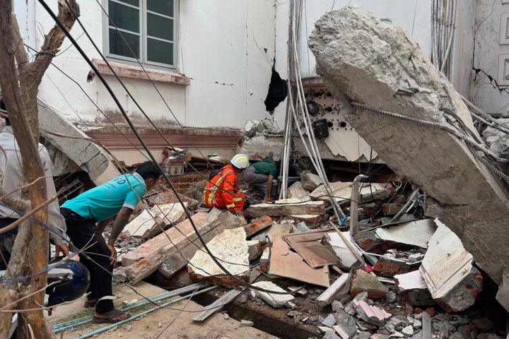 Volunteers look for survivors near a damaged building Friday, March 28, 2025, in Naypyitaw, Myanmar. (AP Photo/Aung Shine Oo)
