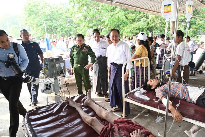 In this image provided by The Myanmar Military True News Information Team, Myanmar's military leader Senior Gen. Min Aung Hlaing, center, visits a site treating victims of an earthquake Friday, March 28, 2025, in Naypyitaw, Myanmar. (The Myanmar Military True News Information Team via AP)