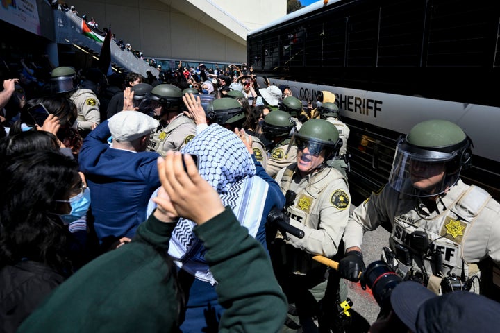 Police push Pro-Palestinian protesters away from a bus carrying arrested protesters at UC San Diego, May 6, 2024, in San Diego. (AP Photo/Denis Poroy, File)