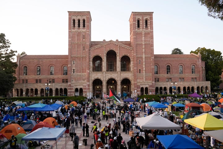 Demonstrators walk in an encampment on the UCLA campus after clashes between pro-Israel and pro-Palestinian groups, May 1, 2024, in Los Angeles. (AP Photo/Jae C. Hong, File)