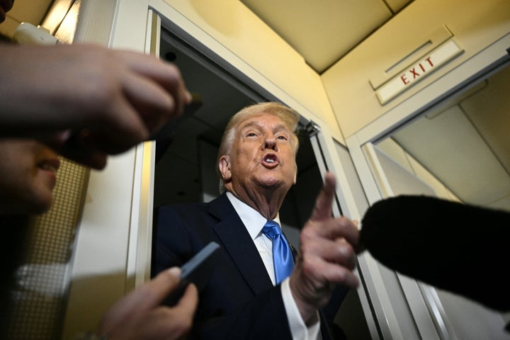 President Donald Trump speaks to the press aboard Air Force One before arriving at Palm Beach International Airport in West Palm Beach, Florida, on March 28, 2025.