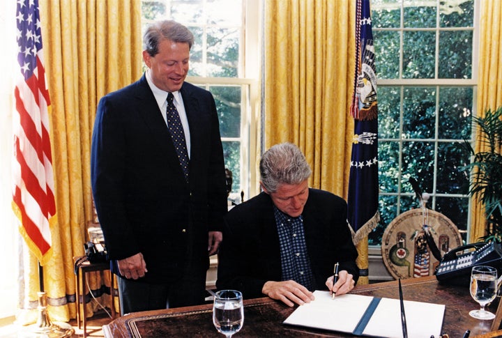 U.S. Vice President Al Gore (left) watches as President Bill Clinton signs an executive order in the White House's Oval Office on Aug, 9, 1997. That particular executive order was designed to protect federal employees and the public from exposure to tobacco smoke in federal workplaces.