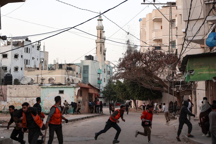 People and Palestinian rescuers run for cover as Israeli strike hits a school in the al-Tuffah neighbourhood in Gaza City on April 3, 2025. Gaza's civil defence agency said at least 21 people were killed on April 3 in an Israeli air strike on a school serving as a shelter for people displaced by the war.