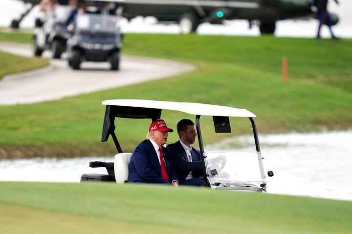President Donald Trump, driven by his son Eric Trump, arrives at Trump National Doral during the LIV Golf Miami tournament, Thursday, April 3, 2025, in Miami. (AP Photo/Alex Brandon)