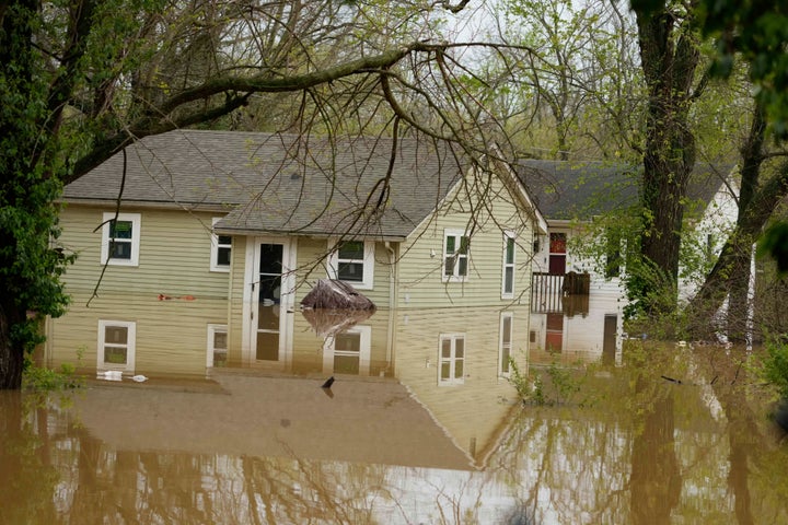 Flood waters rise around homes on Bell Street in Hopkinsville, Ky., Friday, April 4, 2025. (AP Photo/George Walker IV)