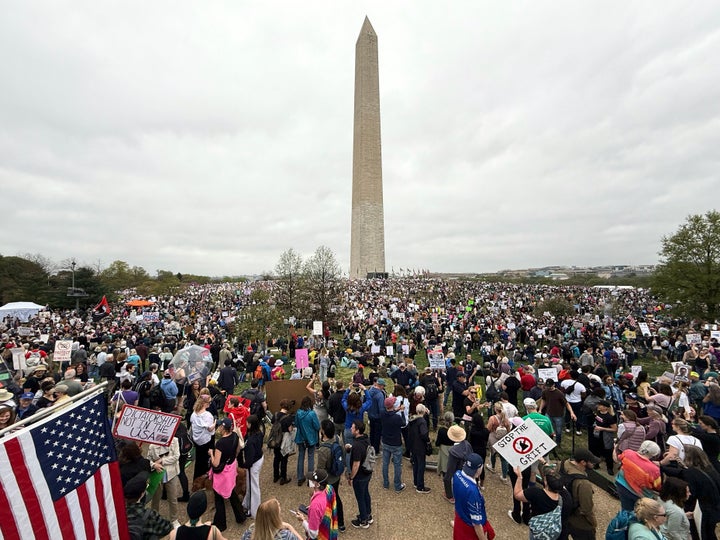 Opponents of President Donald Trump protest near the Washington Monument, Saturday, April 5, 2025, in Washington. (AP Photo/Jose Luis Magana)