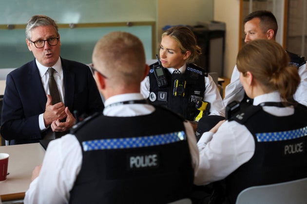 Keir Starmer speaks with Territorial Support Group public order officers in the canteen at Lambeth Police Headquarters in London, Friday Aug. 9, 2024.