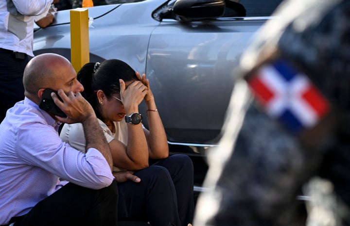 A woman cries outside of the Jet Set nightclub a day after the collapse of its roof in Santo Domingo on April 9, 2025. (Photo by MARTIN BERNETTI/AFP via Getty Images)